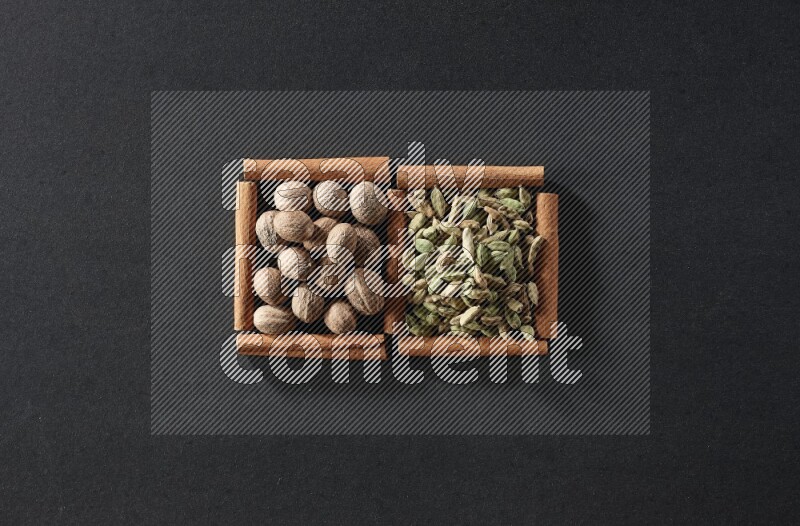 2 squares of cinnamon sticks full of nutmegs and cardamom on black flooring