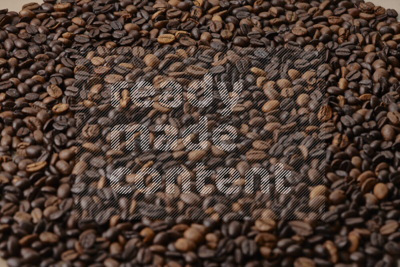 Roasted coffee beans on beige background