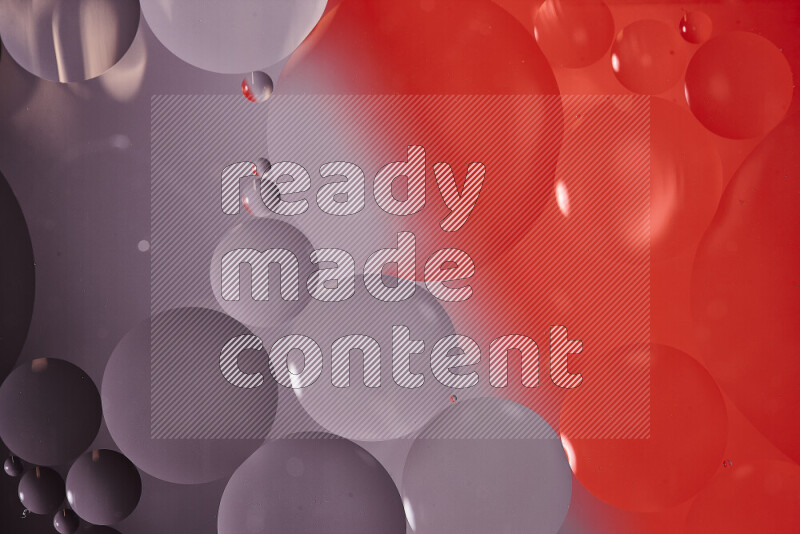 Close-ups of abstract oil bubbles on water surface in shades of white and red