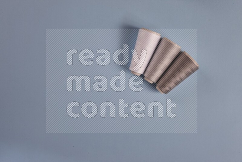 A grey collection of sewing and tailoring tools arranged on a blue background