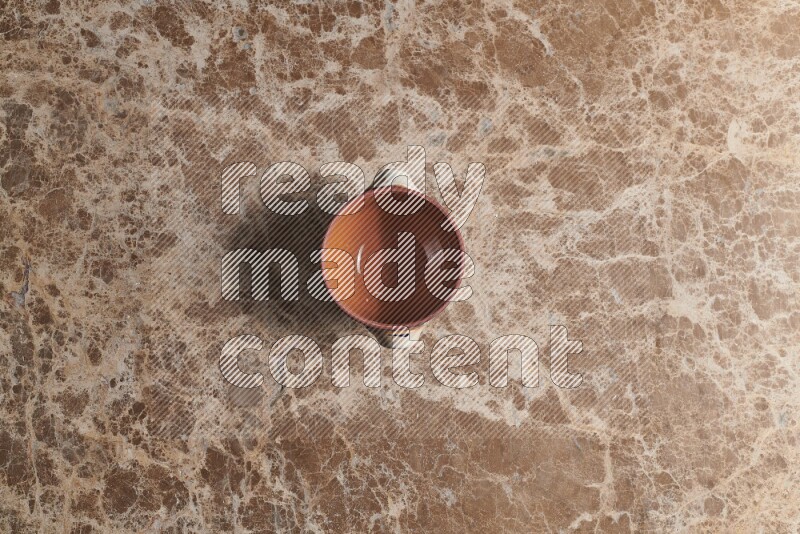 A multicolored pottery pot on beige marble background