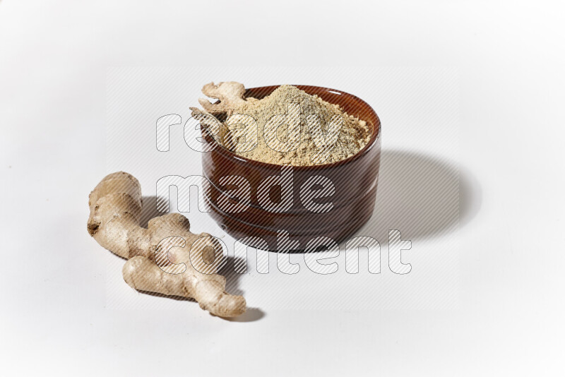 A brown pottery bowl full of ground ginger powder on white background