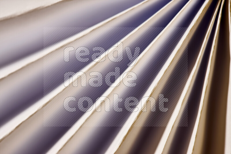 An image presenting an abstract paper pattern of lines in white and gold tones