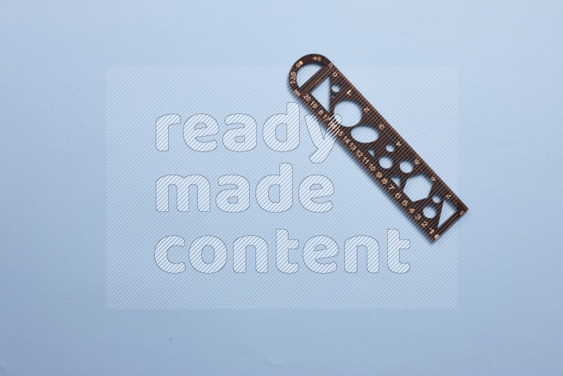 A wooden ruler on blue background