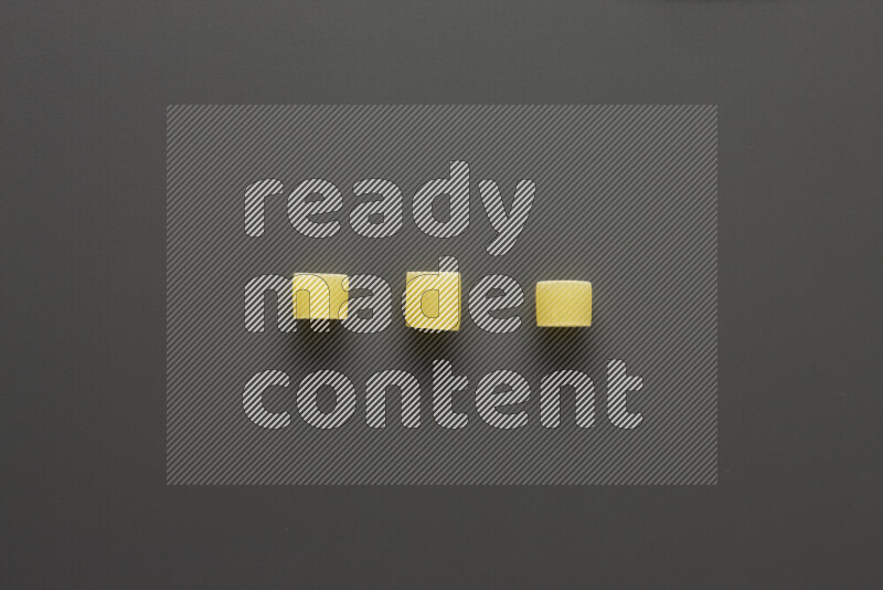 Big rings pasta on grey background