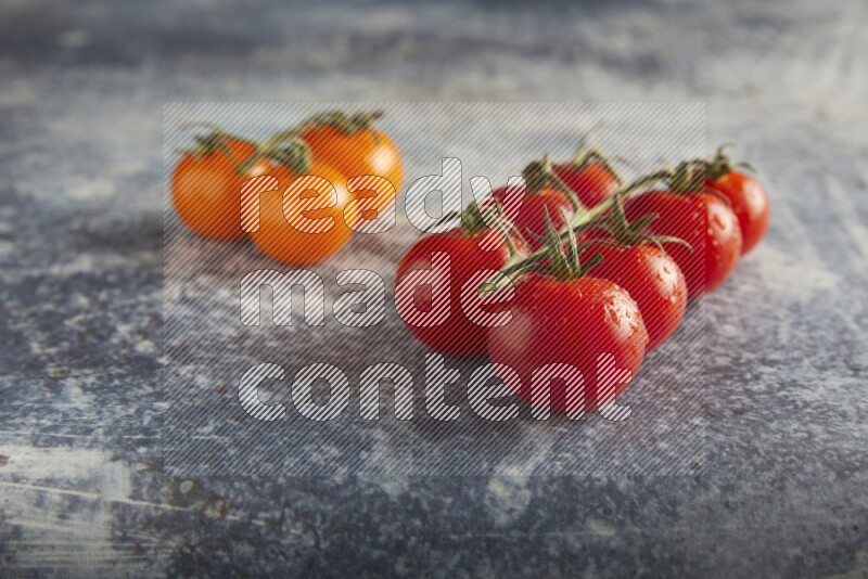 Mixed cherry tomato veins on a textured rustic blue background 45 degree