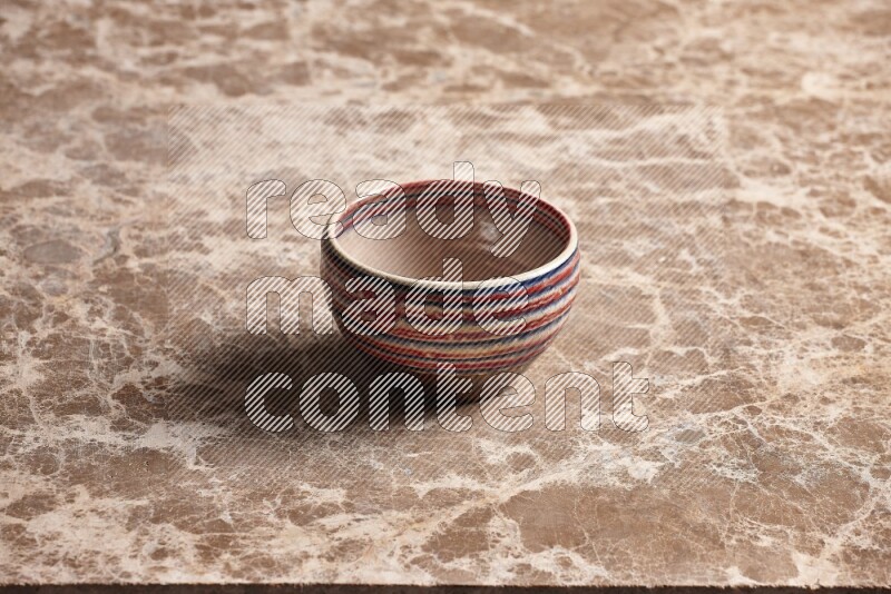 Multicolored Pottery Bowl on Beige Marble Flooring