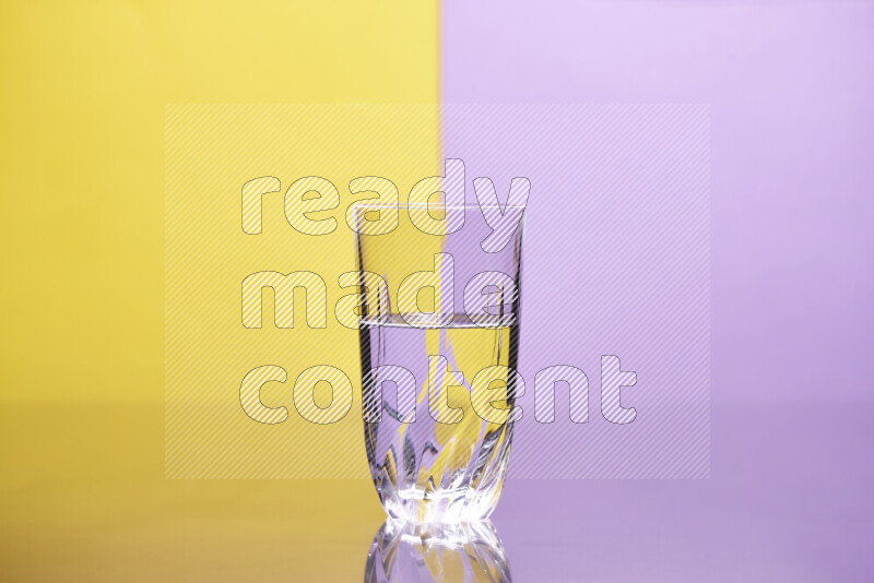 The image features a clear glassware filled with water, set against yellow and light purple background