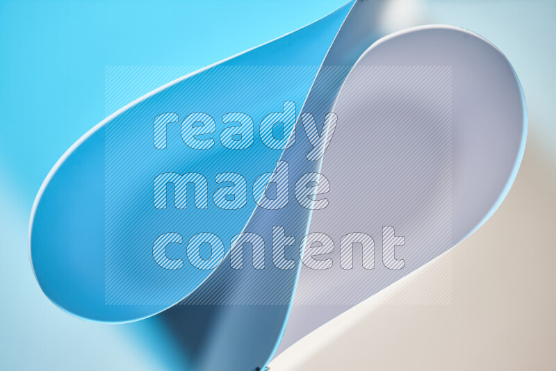 An abstract art of paper folded into smooth curves in white and blue gradients