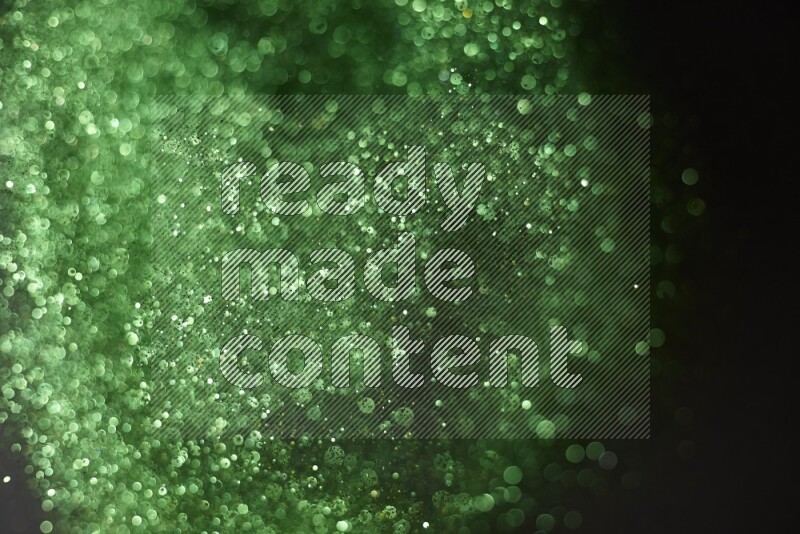 Green glitter powder isolated on black background