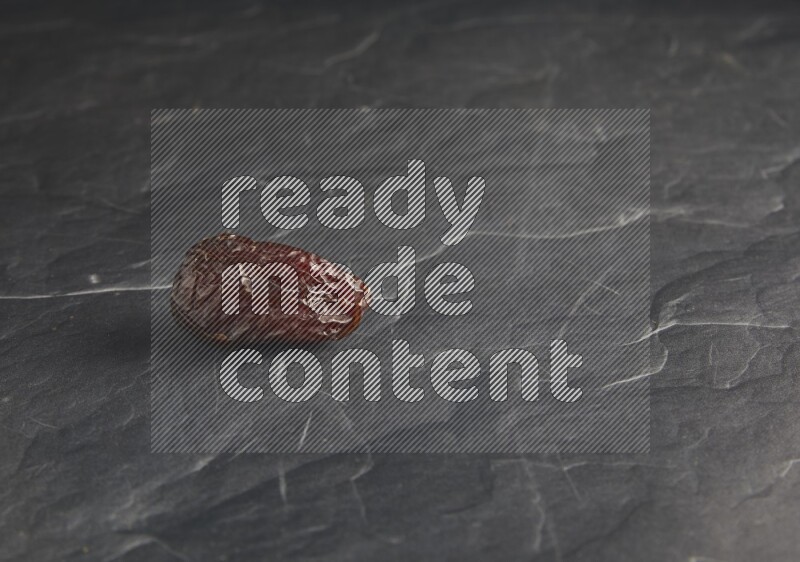 one madjoul date on a black textured background