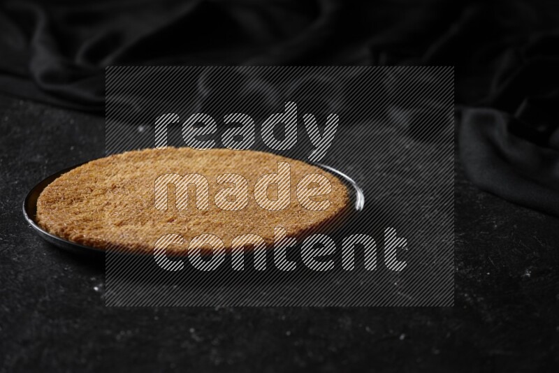 Konafa in different plates in a dark setup