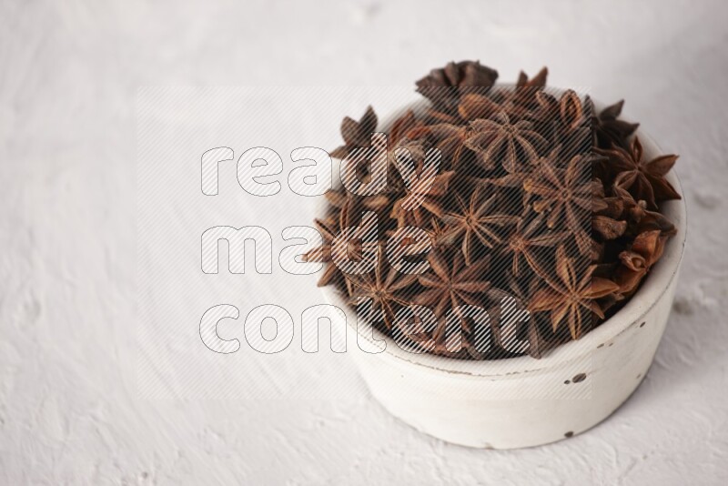 Star Anise in a white bowl on white background