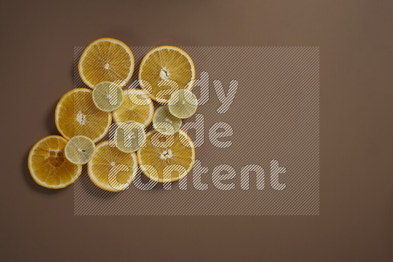 Some of citrus fruits such as lemon, lime and oranges lying on beige background