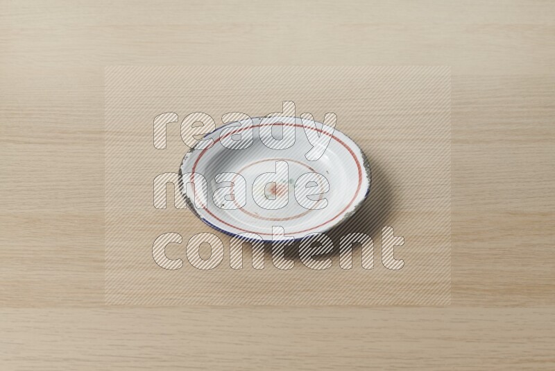 A vintage metal plate on light wooden background