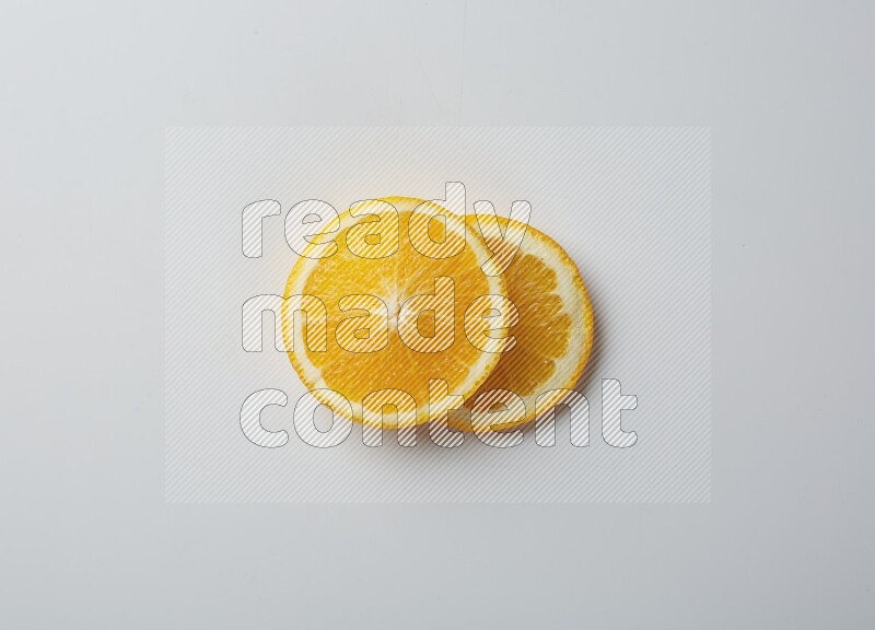 Two orange slices on white background