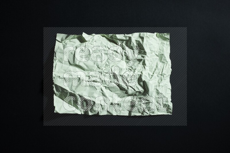 Green paper sheet on black background