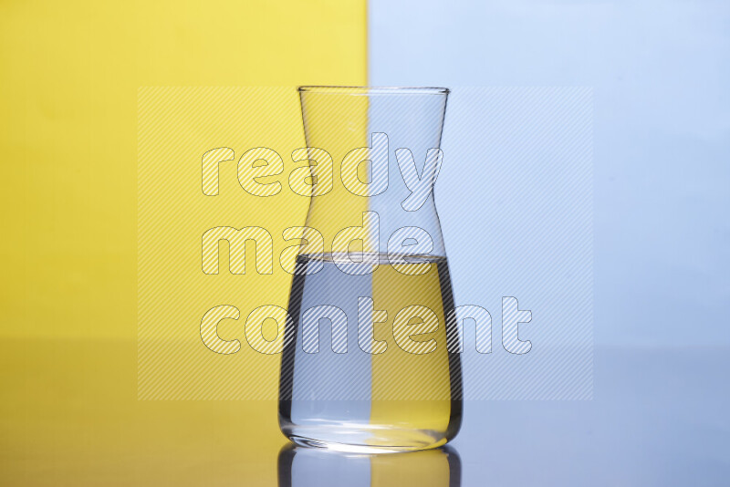 The image features a clear glassware filled with water, set against yellow and light blue background