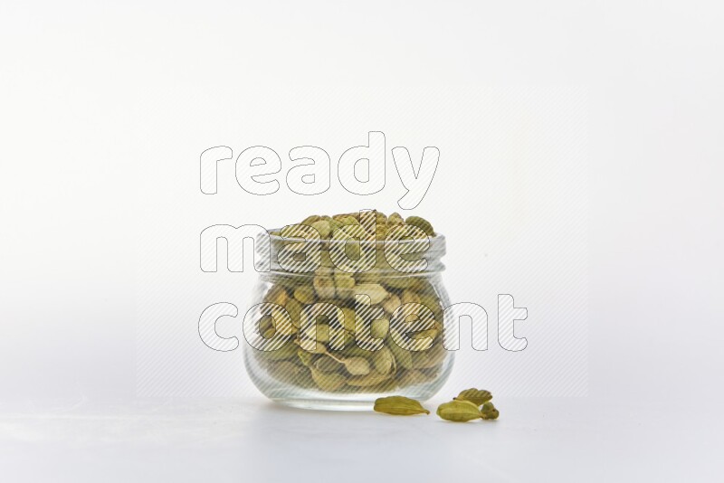 Cardamon in a container on white background