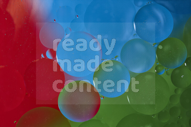 Close-ups of abstract oil bubbles on water surface in shades of blue, red and green