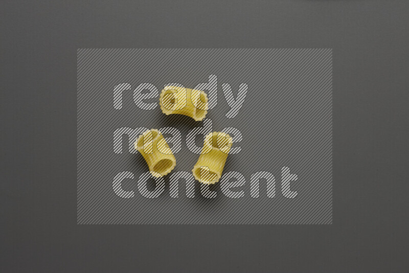 Elbow pasta on grey background