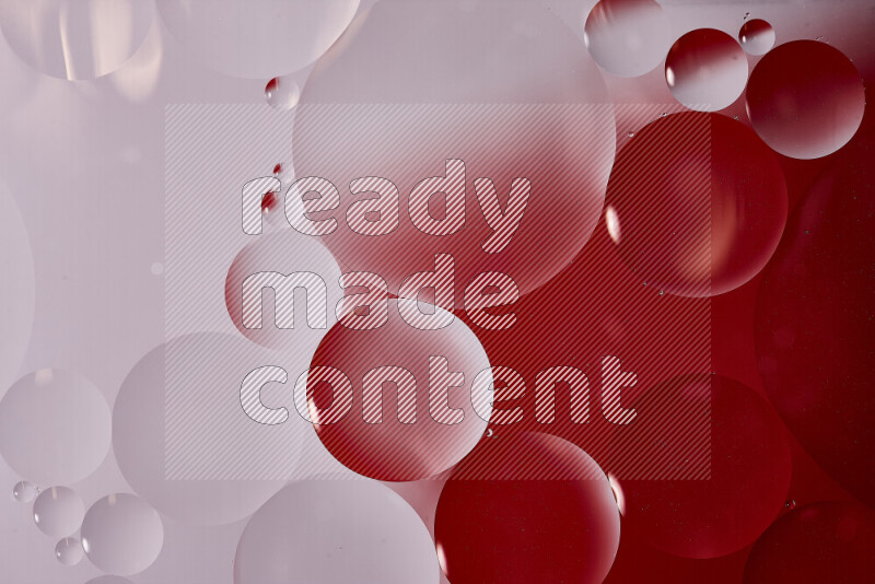 Close-ups of abstract oil bubbles on water surface in shades of white and red