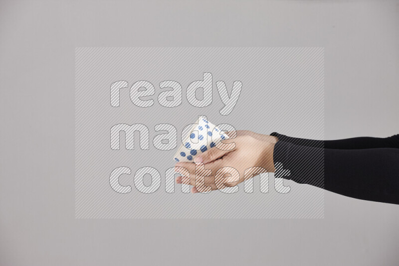 A woman in black abaya holding different pottery essentials in different positions