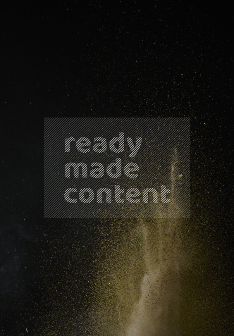 A side view of brown powder explosion on black background
