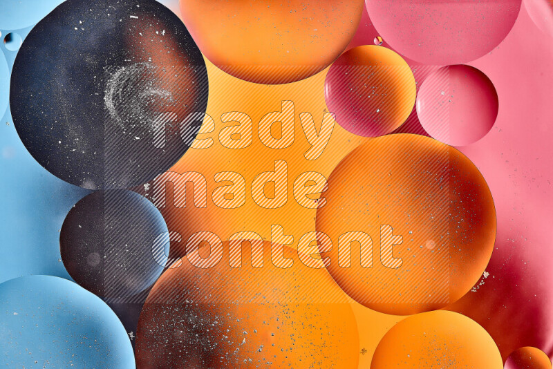 Close-ups of abstract oil bubbles on water surface in shades of blue, orange and pink