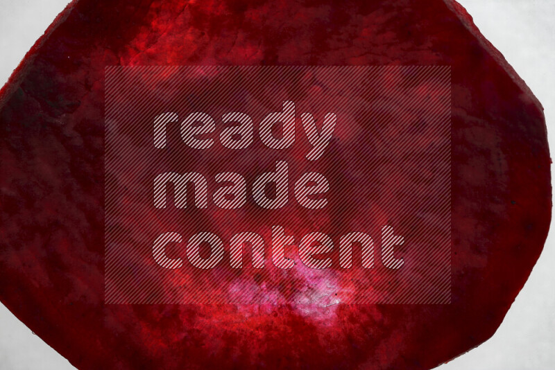 Beet slices on illuminated white background