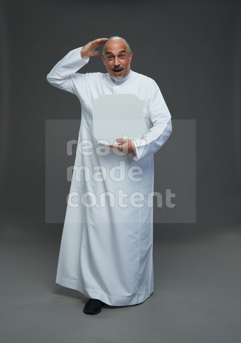 Saudi man without shomag Standing holding social media sing on gray background