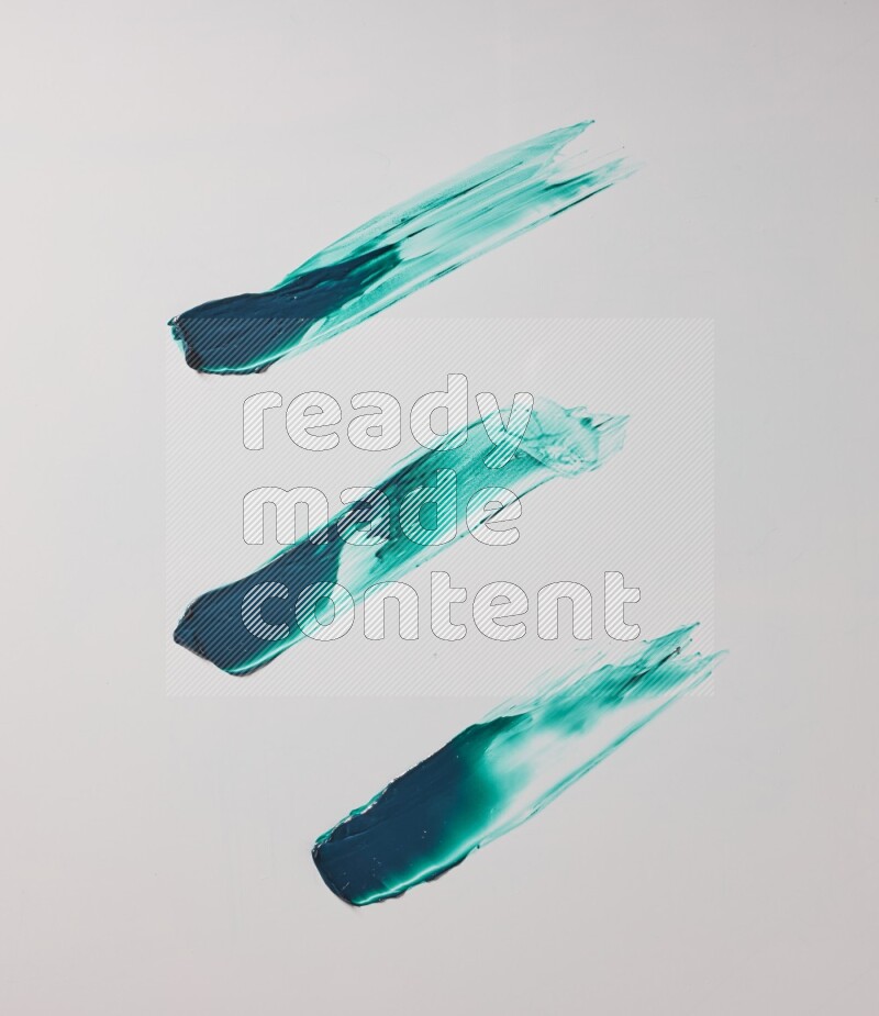 Turquoise painting knife strokes on white background