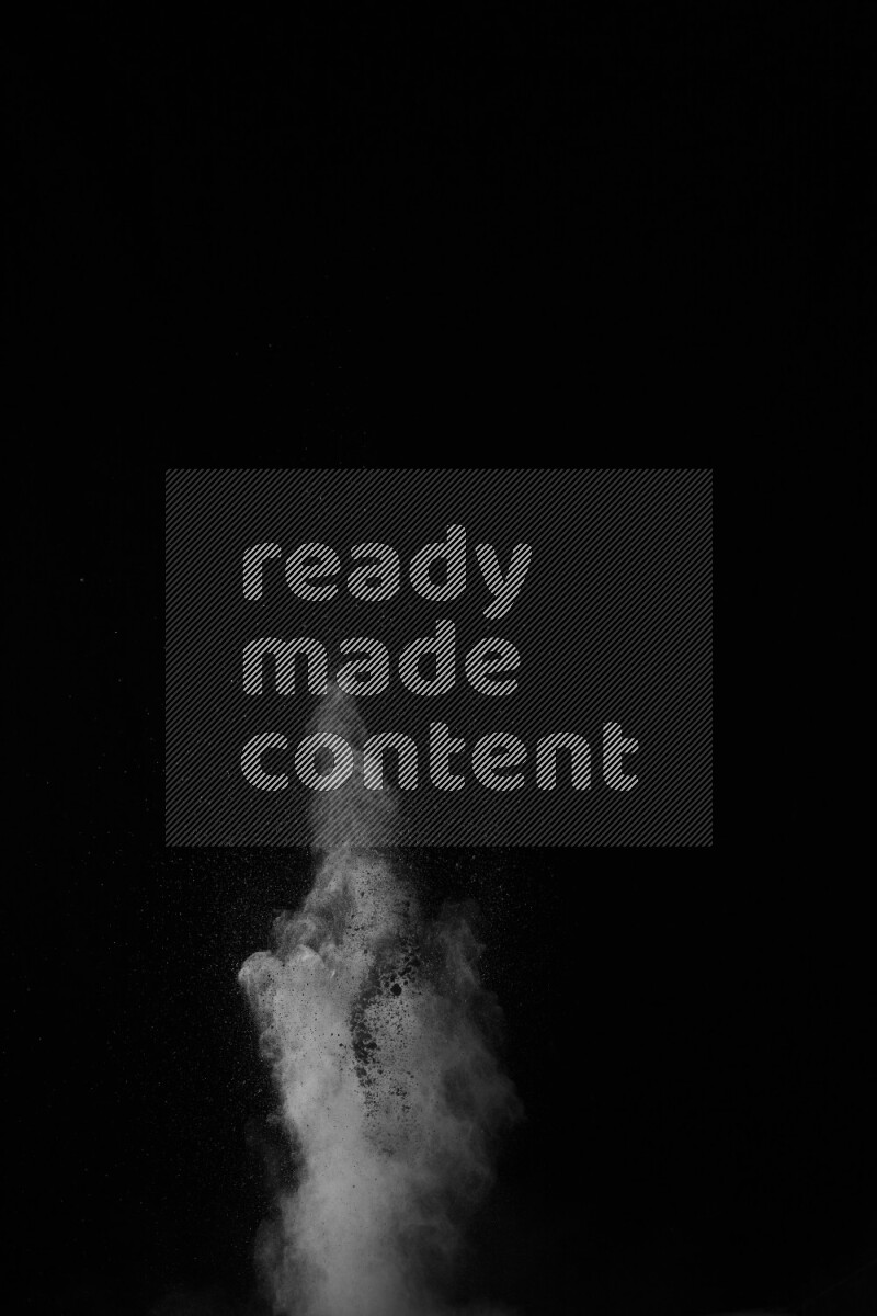 A side view of white powder explosion on black background
