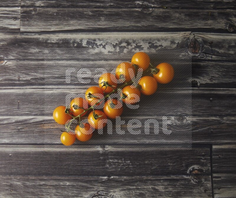 Single cherry tomato vein topview on a grey wooden background