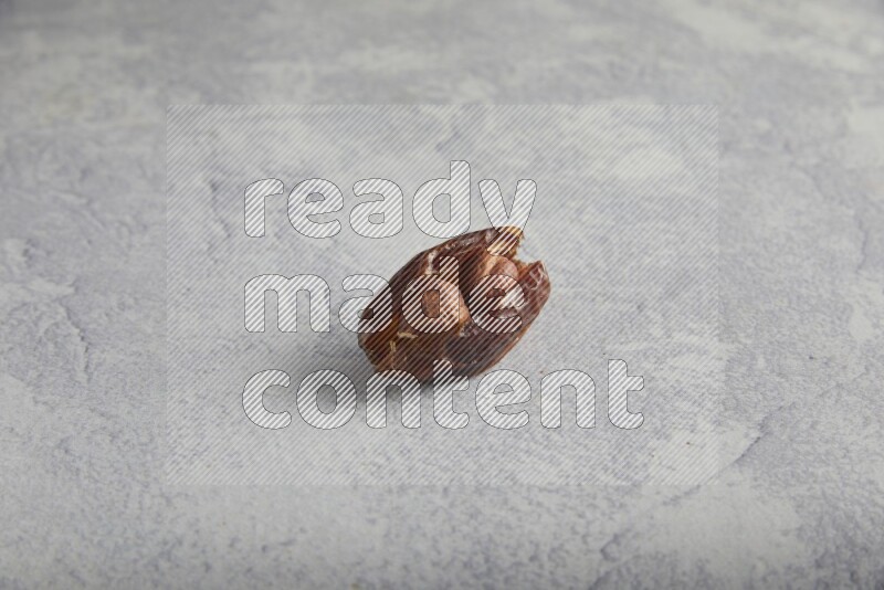 Hazulnut stuffed date on light grey background
