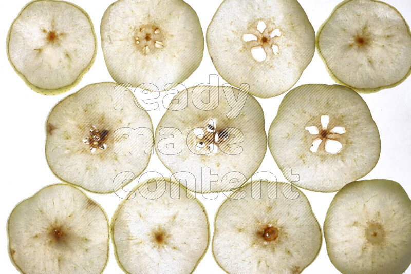 Pear slices on illuminated white background