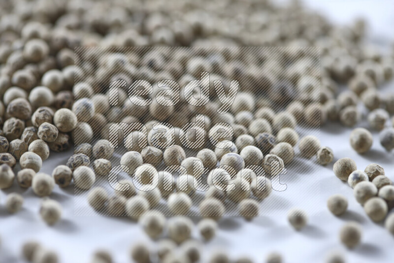 White pepper beads on white background