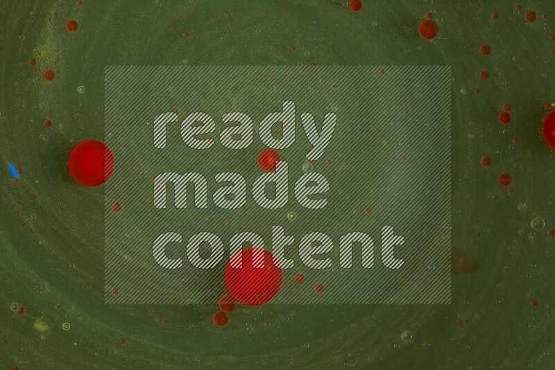 The image captures a dramatic splatter of red paint over a green backdrop