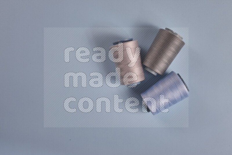 A grey collection of sewing and tailoring tools arranged on a blue background