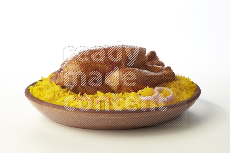 yellow basmati Rice with whole roasted chicken  on a pottery plate  direct  on white background