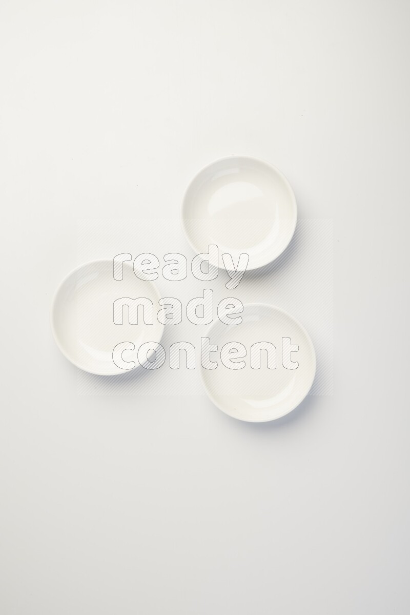 white ceramic round sauce dish on white countertop