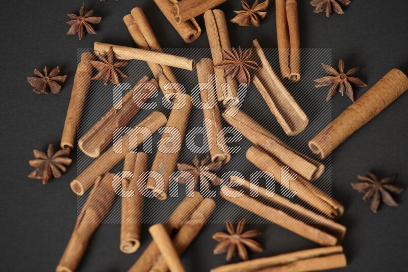 Cinnamon sticks and star anise on black background