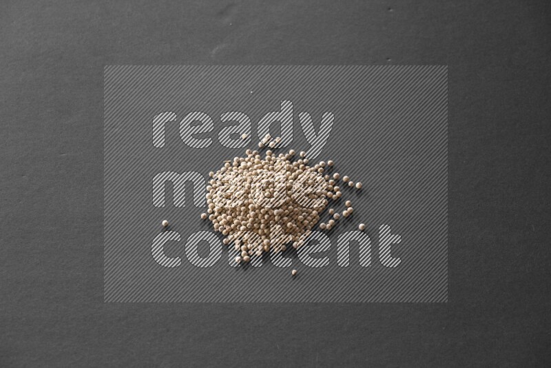 White pepper on a black flooring