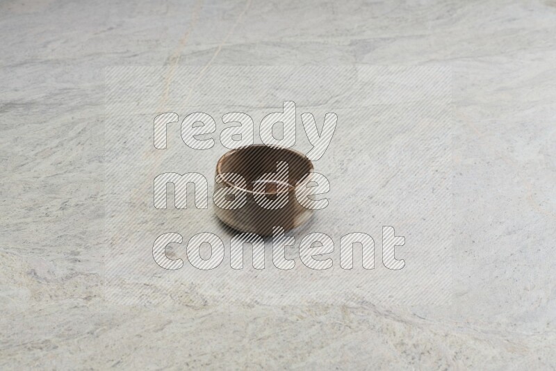 A multicolored pottery bowl on grey marble background