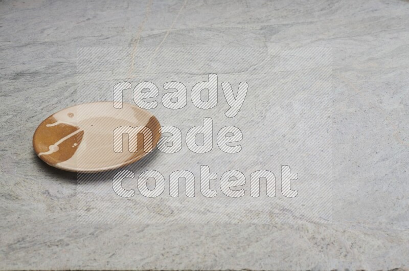Multicolored Pottery Plate On Grey Marble Flooring