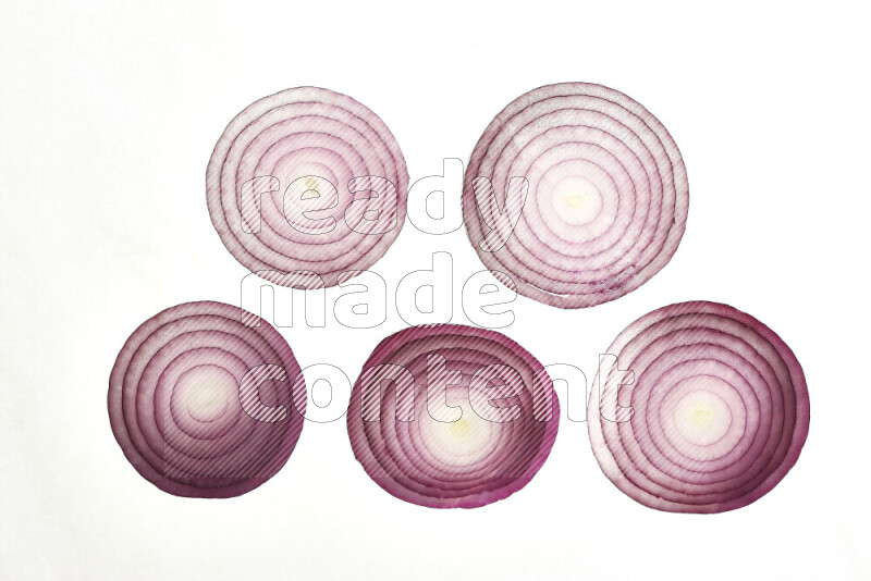 Onion slices on illuminated white background