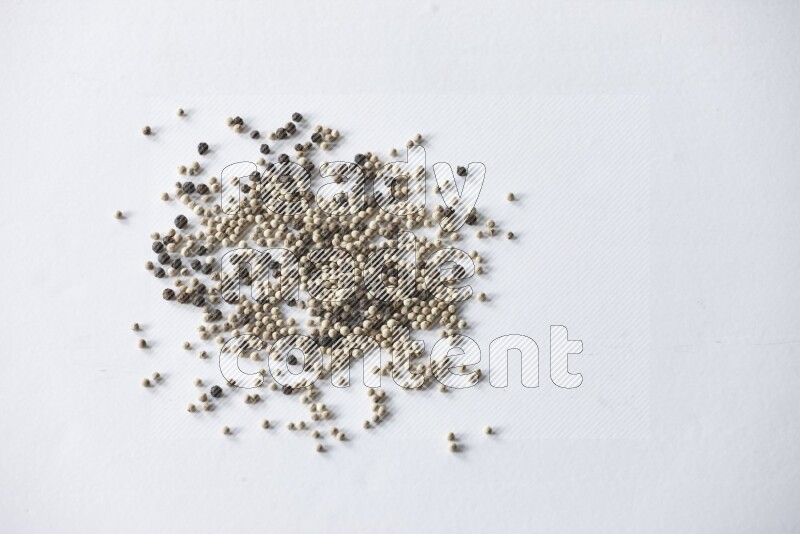 Mixed black and white pepper beads on a white flooring