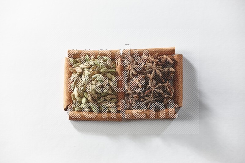 2 squares of cinnamon sticks full of star anise and cardamom on white flooring