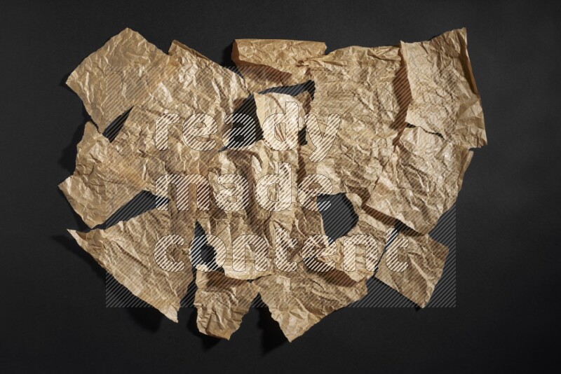 Crumpled craft paper on black background