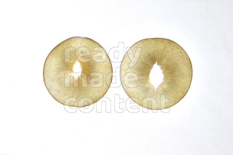 Peach slices on illuminated white background